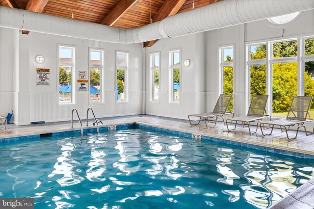 an aerial view of residential houses with outdoor space and swimming pool