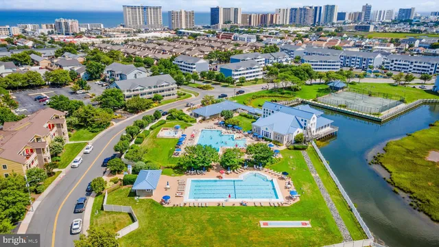 an aerial view of a house with a garden and swimming pool