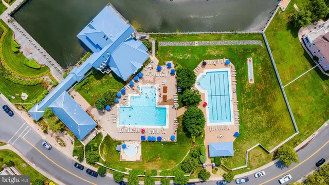 an aerial view of residential houses with outdoor space and street view