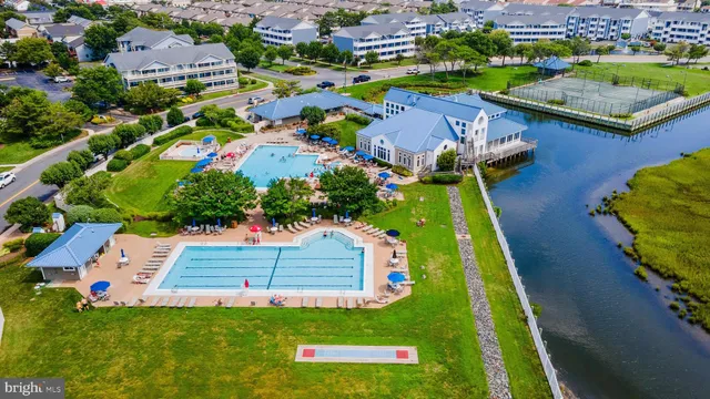 an aerial view of a house with a garden and lake view
