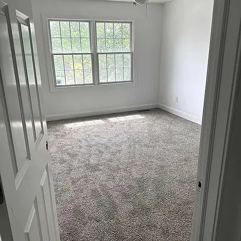 an empty room with a empty space and windows