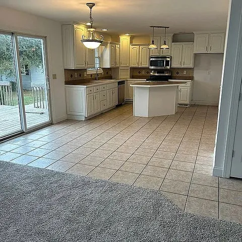 a kitchen with stainless steel appliances a sink stove and cabinets