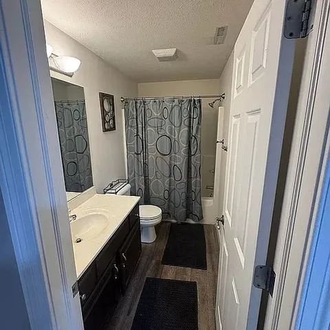 a bathroom with a double vanity sink and a mirror