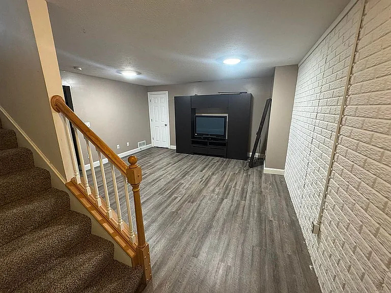 1713 Bob O Link Street Pontiac, IL 61764 - Photo 8 of 17 a view of a livingroom with wooden floor and staircase