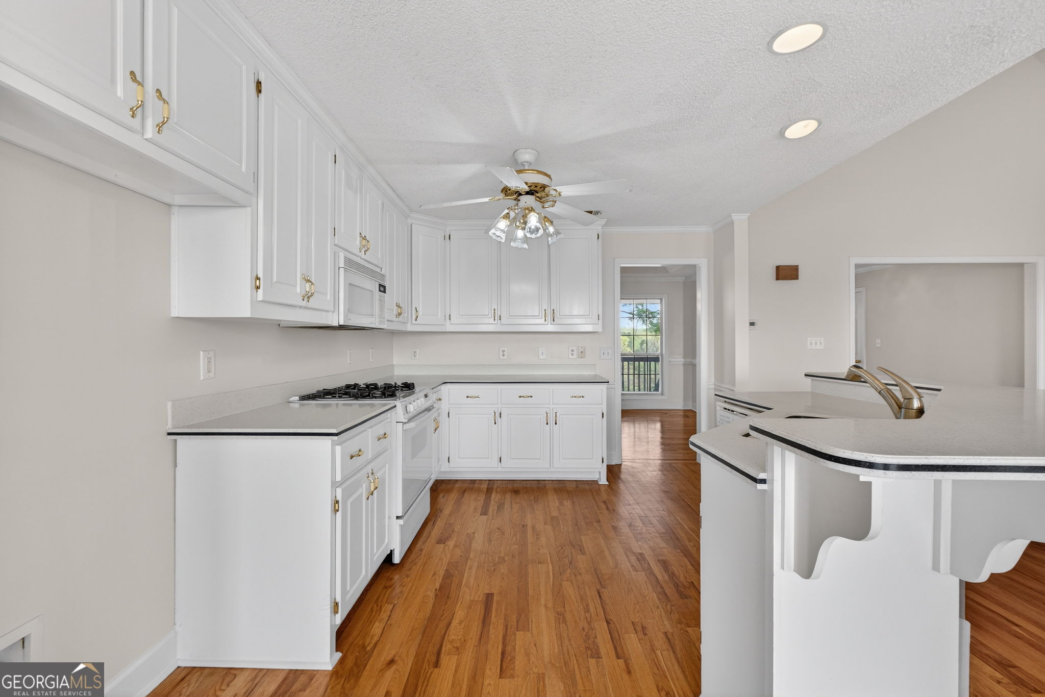 955 Mocassin Gap Road Locust Grove, GA 30248 - Photo 14 of 59 a kitchen with granite countertop a sink cabinets stainless steel appliances and a chandelier