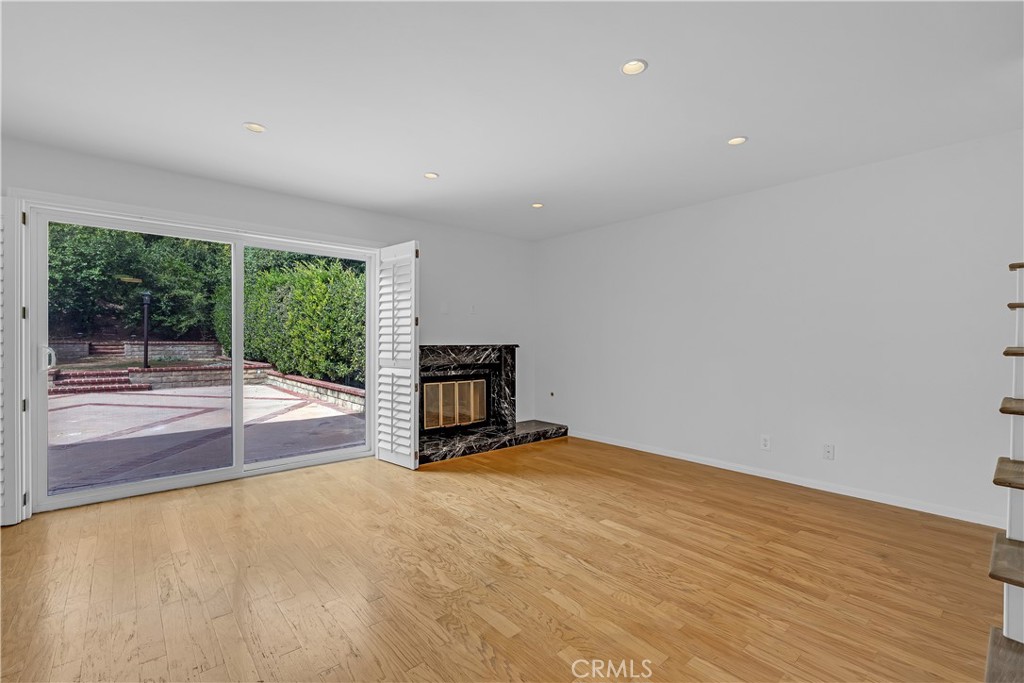 19451 Eagle Ridge Lane Porter Ranch, CA 91326 - Photo 17 of 59 a view of an empty room with wooden floor and a window