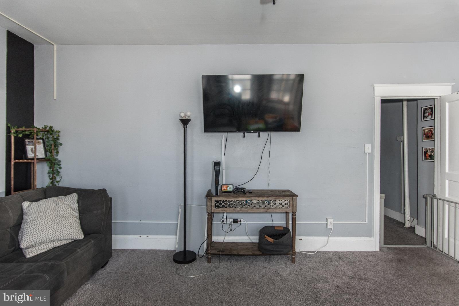 2578 Orthodox Street Philadelphia, PA 19137 - Photo 36 of 62 a living room with a flat screen tv and gym equipment
