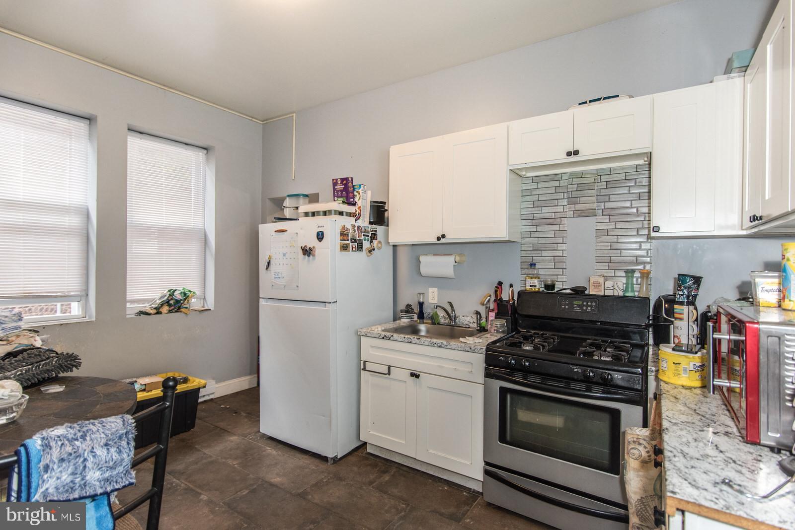 2578 Orthodox Street Philadelphia, PA 19137 - Photo 40 of 62 a kitchen with a stove a sink and a refrigerator