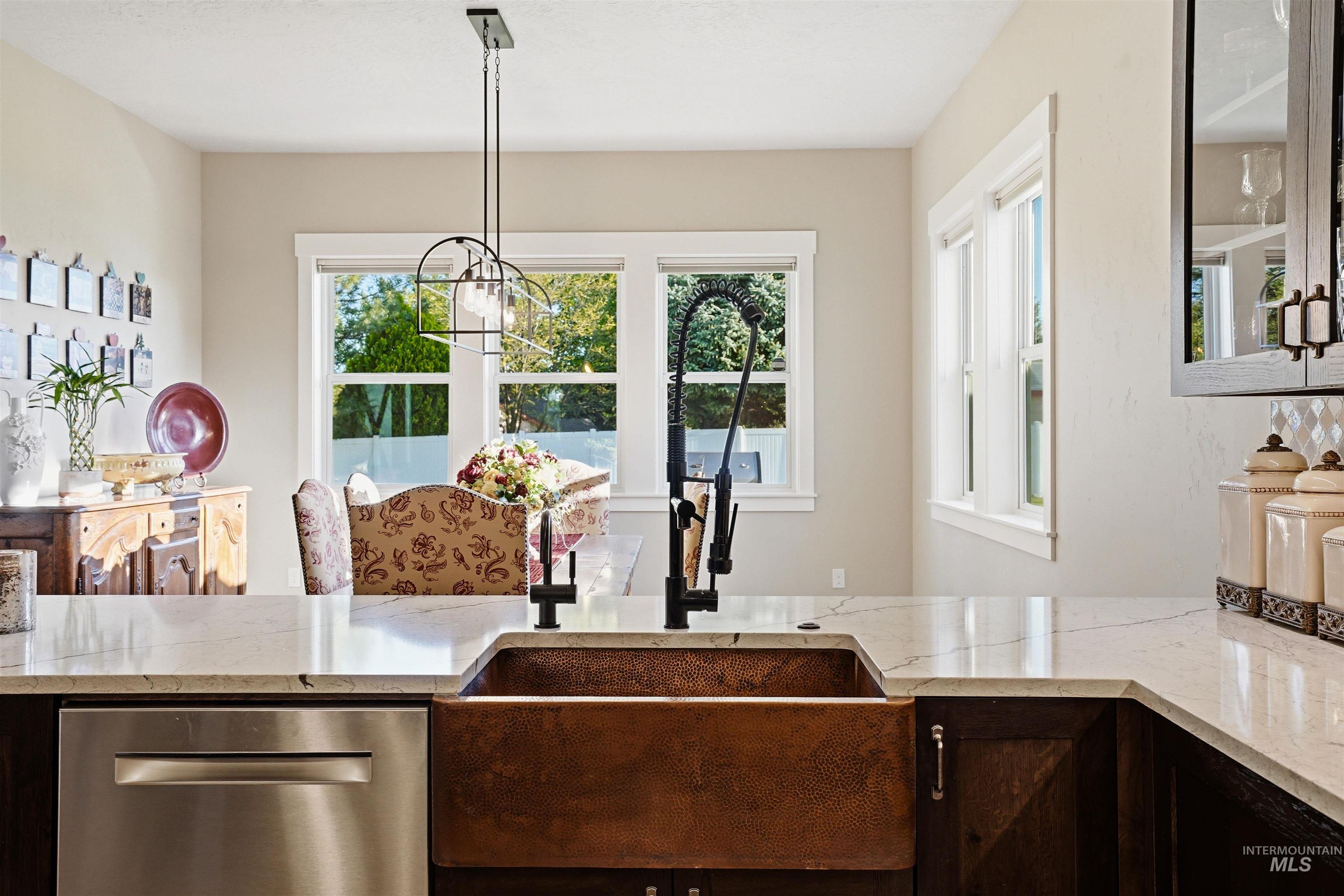 24165 Boer Goat Avenue Caldwell, ID 83607 - Photo 13 of 34 Copper farmhouse sink with a matte black high-arc faucet, set into a light-toned countertop