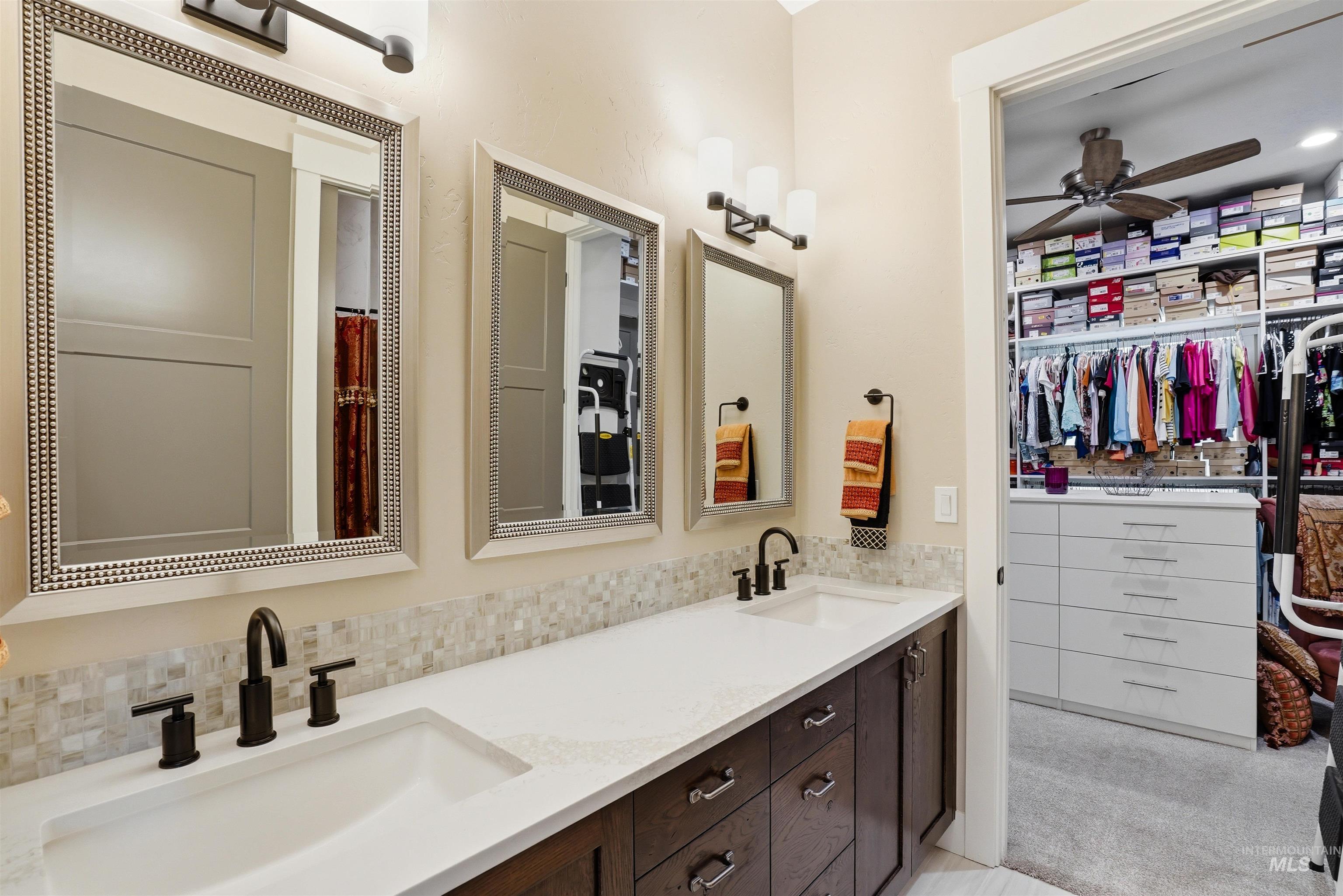 24165 Boer Goat Avenue Caldwell, ID 83607 - Photo 22 of 34 Dual vanity with dark wood-finish cabinetry, white countertops, and matte black fixtures
