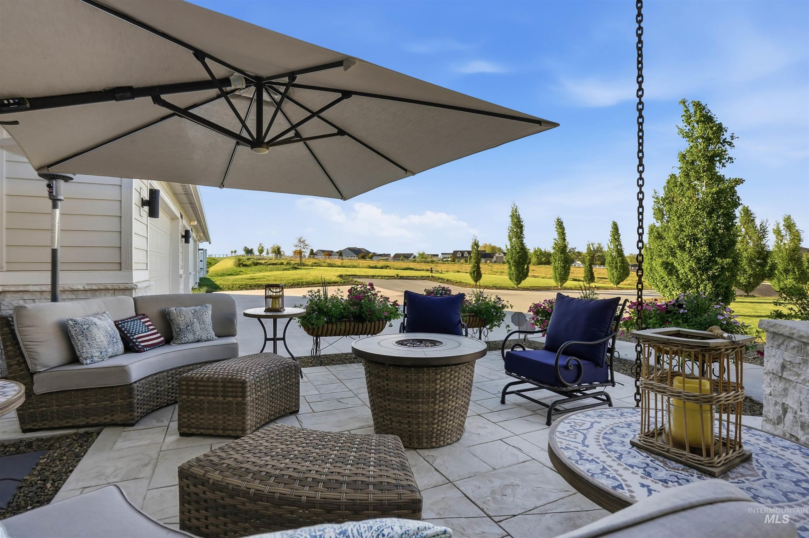 24165 Boer Goat Avenue Caldwell, ID 83607 - Photo 26 of 34 Spacious outdoor patio featuring light-toned paver flooring, a stone-clad exterior wall, and established landscaping