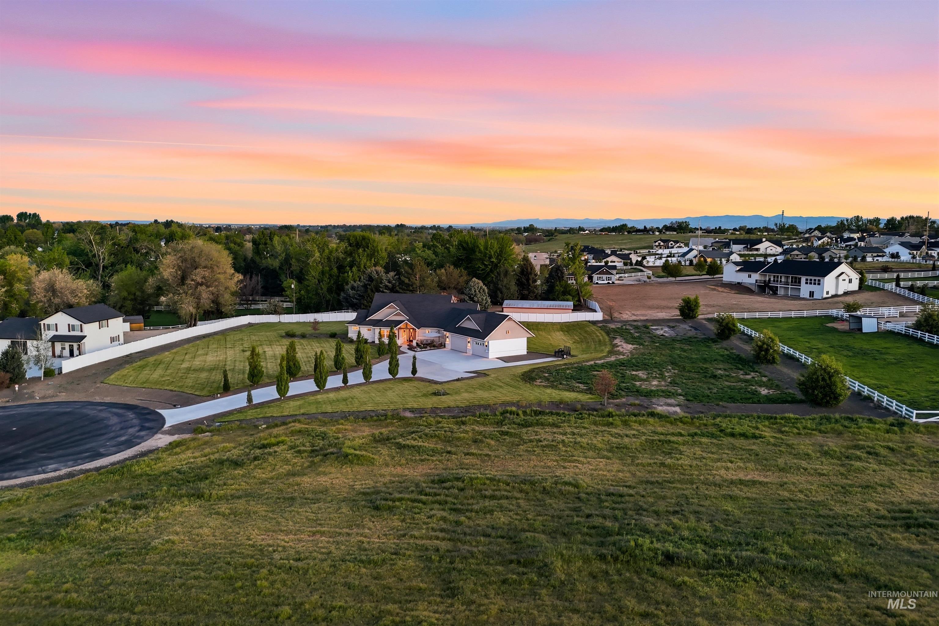24165 Boer Goat Avenue Caldwell, ID 83607 - Photo 3 of 34 Spacious property featuring a large residence, concrete driveway, and established landscaping