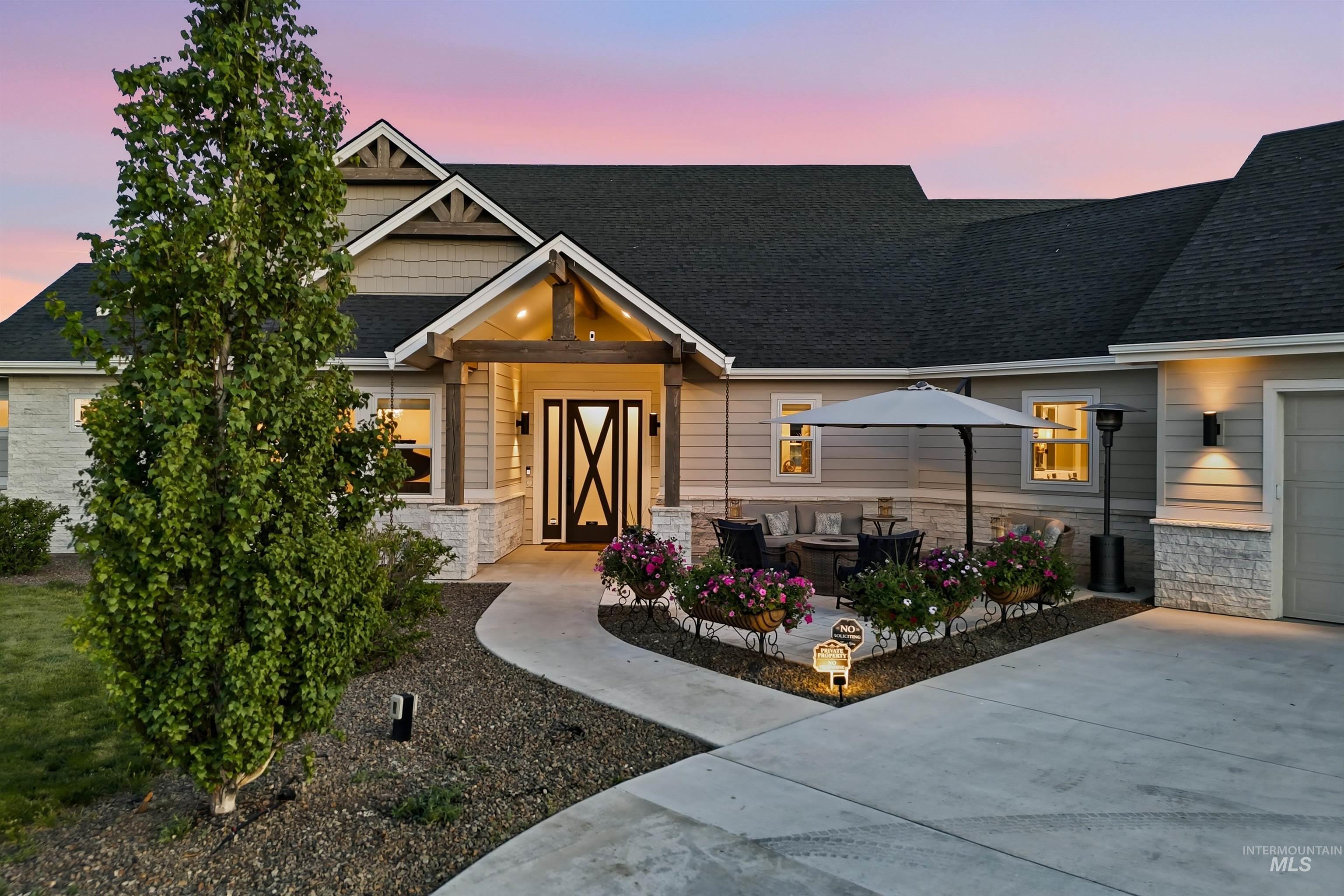 24165 Boer Goat Avenue Caldwell, ID 83607 - Photo 4 of 34 Craftsman-style exterior featuring a covered entry, stone accents, horizontal siding, and a concrete driveway