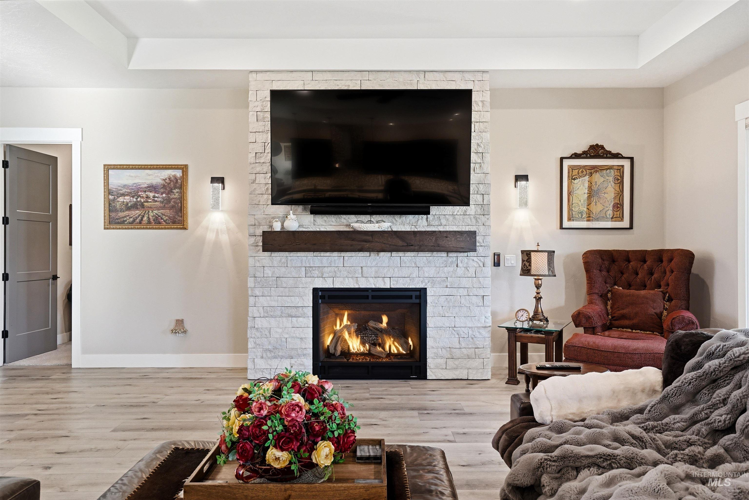 24165 Boer Goat Avenue Caldwell, ID 83607 - Photo 7 of 34 Stone-clad fireplace with a natural wood mantle and built-in media display