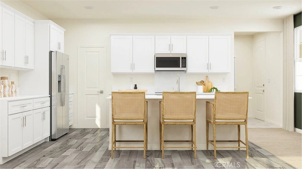 1707 Eagle Road Rialto, CA 92376 - Photo 2 of 18 a kitchen with white cabinets and stainless steel appliances