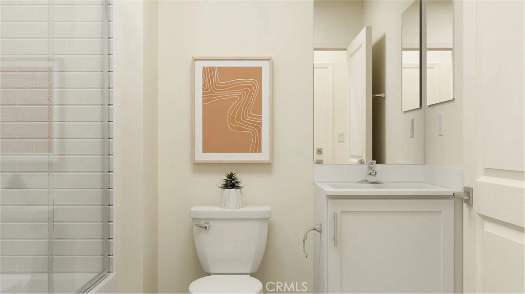 1707 Eagle Road Rialto, CA 92376 - Photo 9 of 18 a bathroom with a toilet sink vanity and mirror