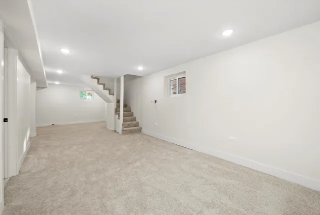 en empty room with stairs and white walls