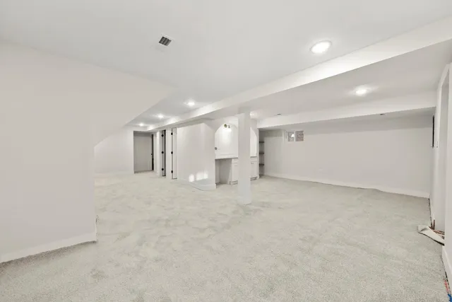 a view of a big room with a refrigerator and window