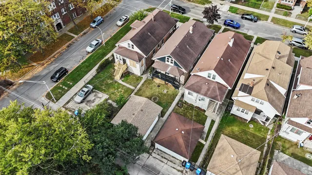 an aerial view of a house with a yard