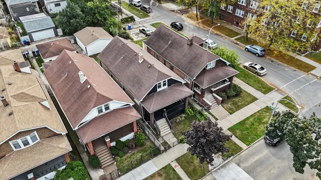 an aerial view of a house with a yard