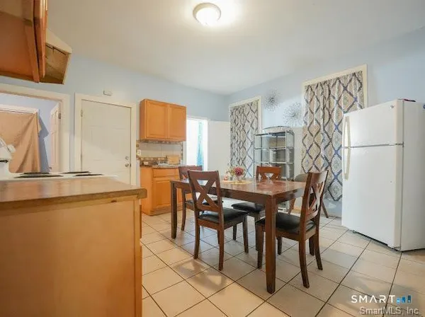 a view of a dining room with furniture and a chandelier