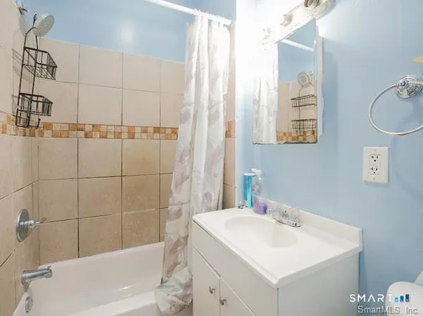 a bathroom with a sink shower and a bathtub