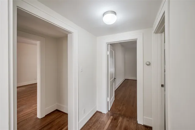 a view of hallway with wooden floor