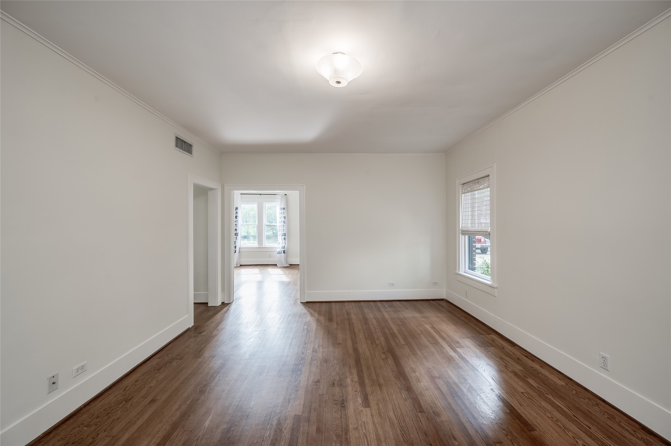 1737 Albans Road, Unit 1 Houston, TX 77005 - Photo 9 of 20 an empty room with wooden floor and windows
