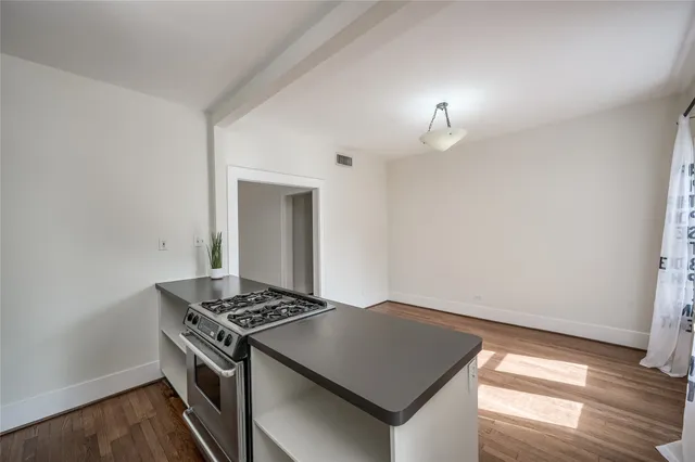 a kitchen that has a stove and a table