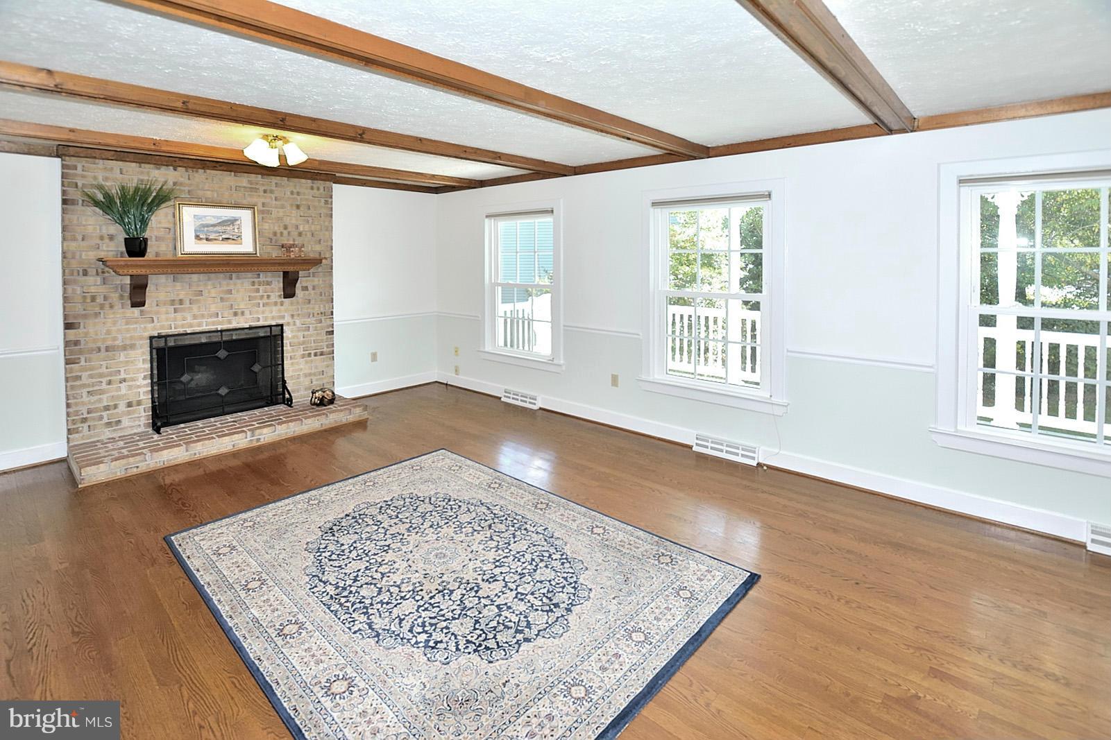 2805 Rifle Ridge Road Oakton, VA 22124 - Photo 4 of 30 a view of an empty room with wooden floor fireplace and a window