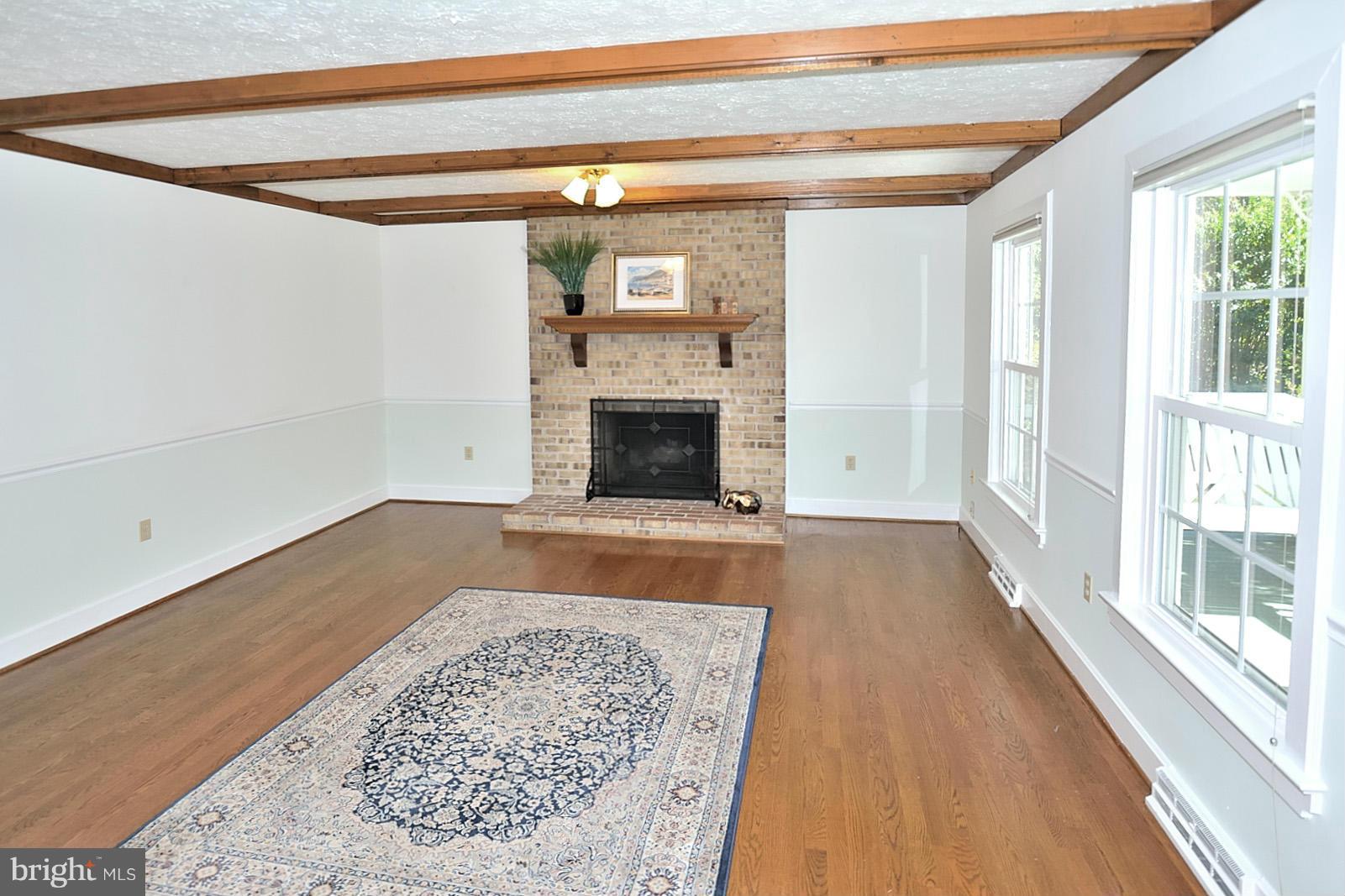 2805 Rifle Ridge Road Oakton, VA 22124 - Photo 5 of 30 a view of empty room with wooden floor and fireplace