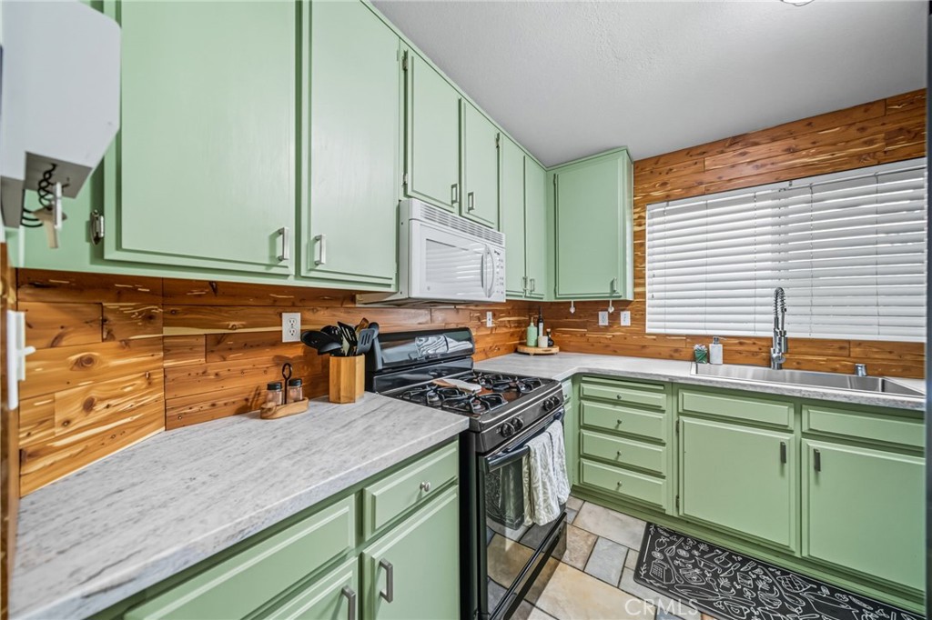 29787-29787 Berea Road Menifee, CA 92584 - Photo 17 of 45 a kitchen with green cabinets a sink and a stove