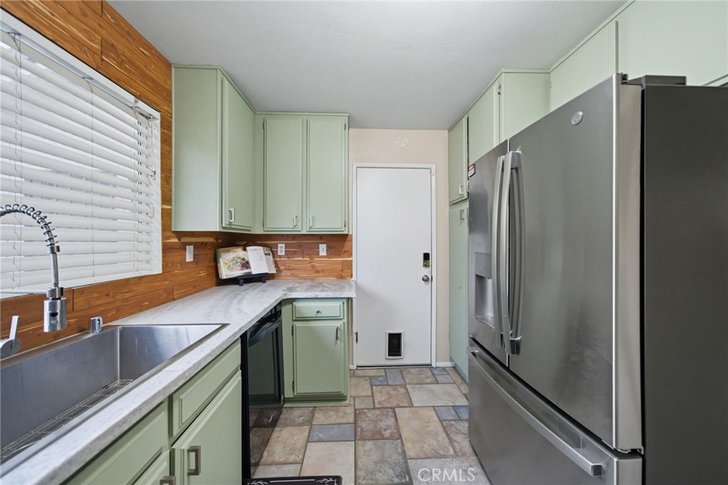 29787-29787 Berea Road Menifee, CA 92584 - Photo 18 of 45 a kitchen with a sink a refrigerator and cabinets