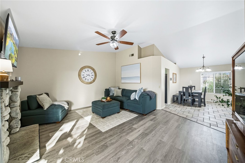 29787-29787 Berea Road Menifee, CA 92584 - Photo 24 of 45 a living room with furniture a clock on the wall and a flat screen tv
