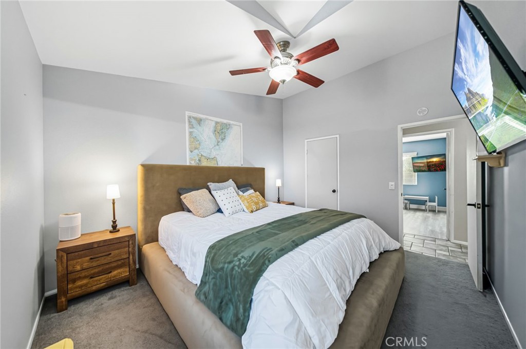 29787-29787 Berea Road Menifee, CA 92584 - Photo 30 of 45 a bedroom with a bed and a chandelier