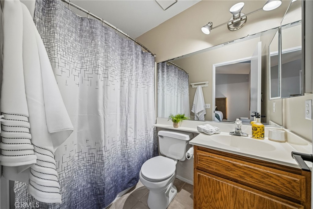 29787-29787 Berea Road Menifee, CA 92584 - Photo 32 of 45 a bathroom with a granite countertop toilet sink and mirror