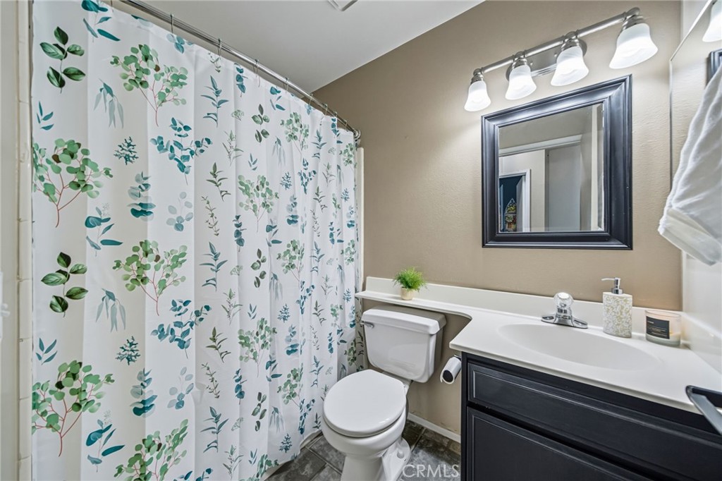 29787-29787 Berea Road Menifee, CA 92584 - Photo 37 of 45 a bathroom with a sink toilet and a mirror