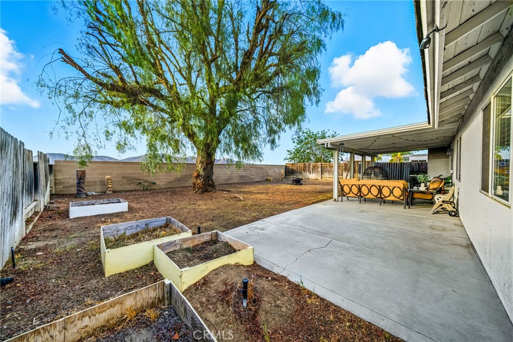 29787-29787 Berea Road Menifee, CA 92584 - Photo 45 of 45 a view of a patio with table and chairs under an umbrella with large trees