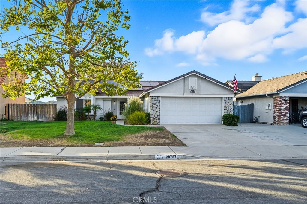 29787-29787 Berea Road Menifee, CA 92584 - Photo 5 of 45 a front view of a house with a yard and garage