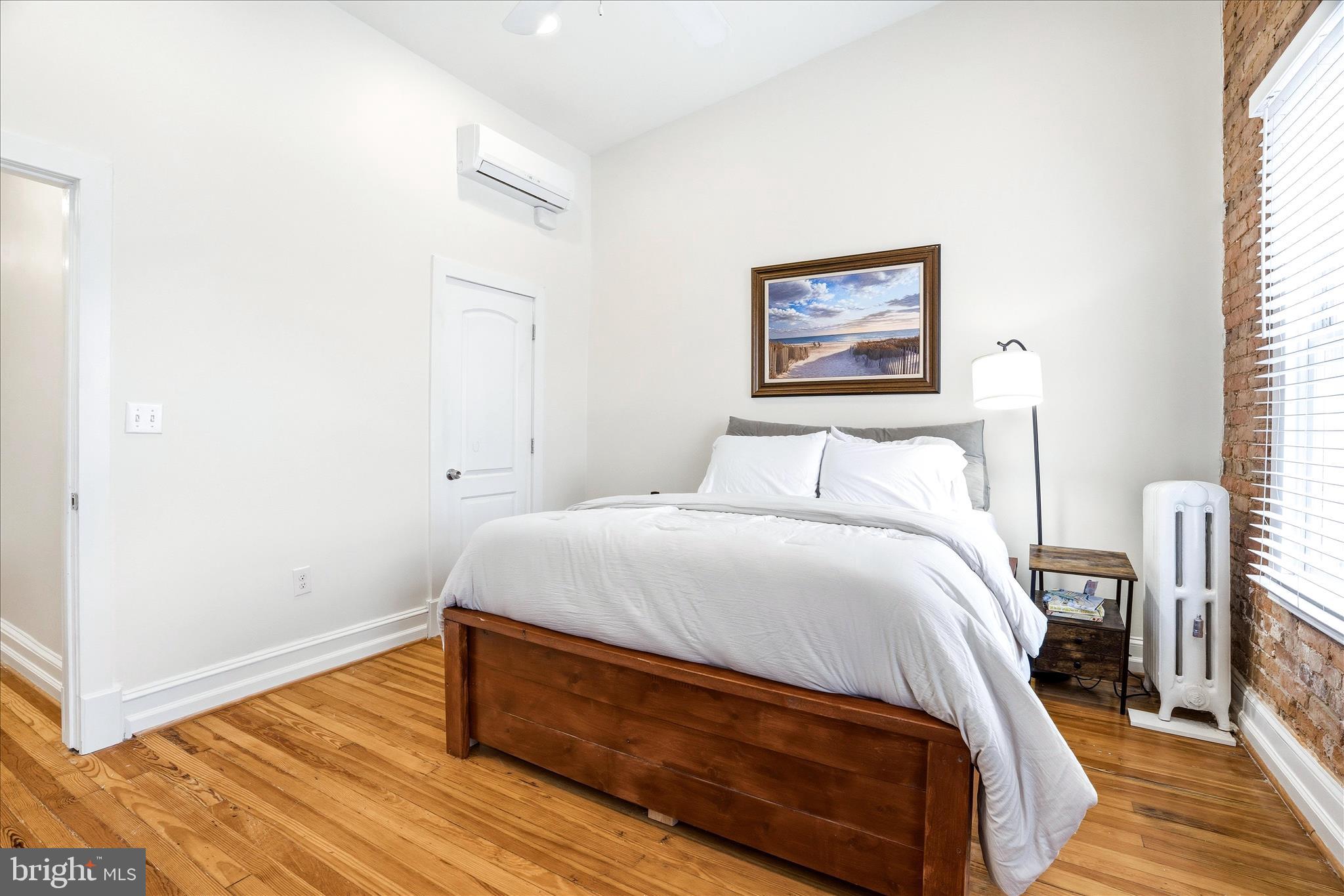 205 East 4th Street Frederick, MD 21701 - Photo 13 of 38 a bedroom with a bed and a painting on the wall