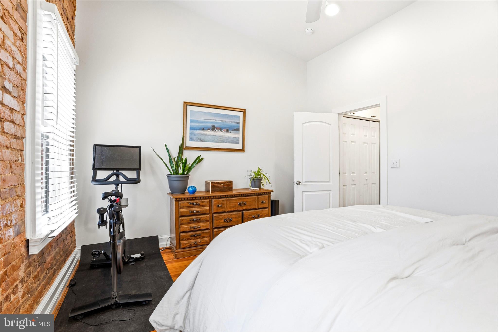 205 East 4th Street Frederick, MD 21701 - Photo 14 of 38 a bedroom with a bed and a flat tv screen on a dresser