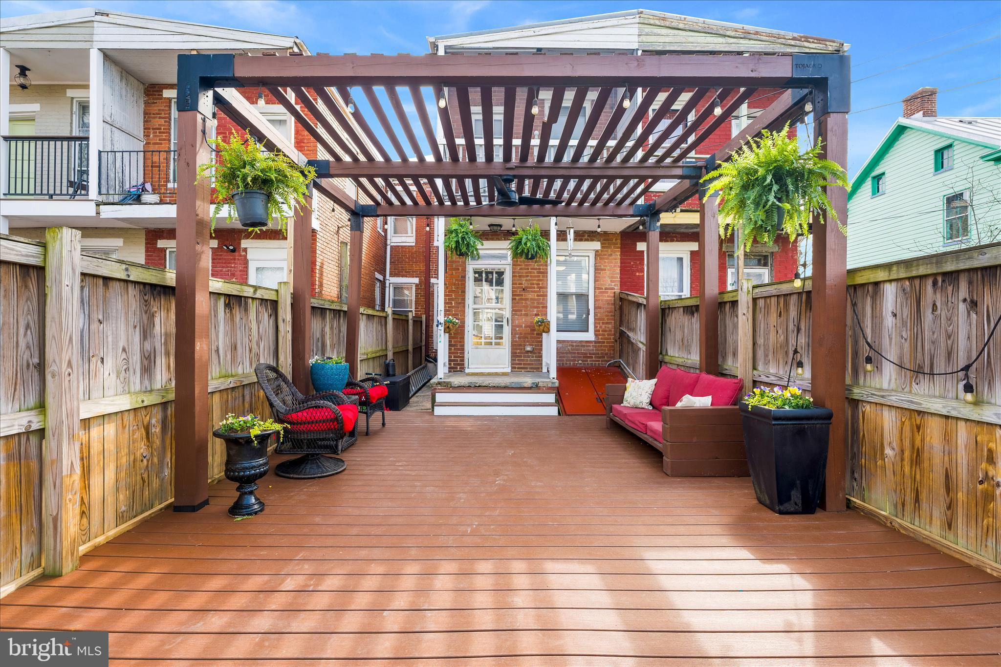 205 East 4th Street Frederick, MD 21701 - Photo 26 of 38 a backyard of a house with barbeque oven table and chairs