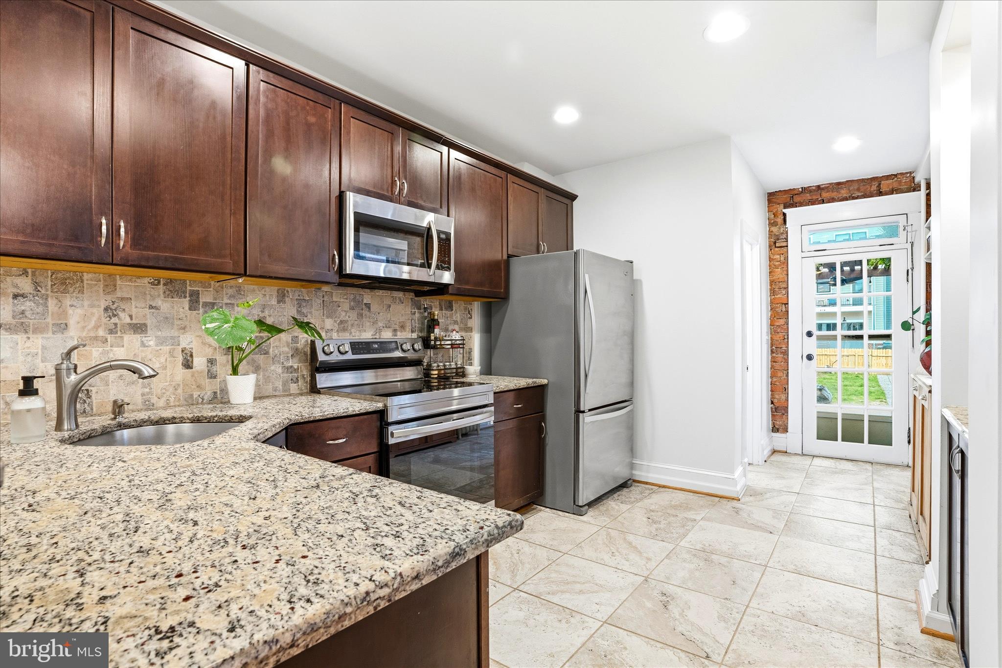 205 East 4th Street Frederick, MD 21701 - Photo 7 of 38 a kitchen with stainless steel appliances granite countertop a refrigerator stove and oven