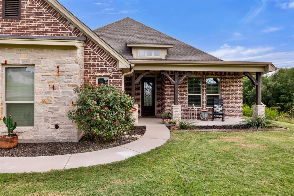 2103 Cash Point Court Granbury, TX 76049 - Photo 3 of 38 a view of a house with yard and porch