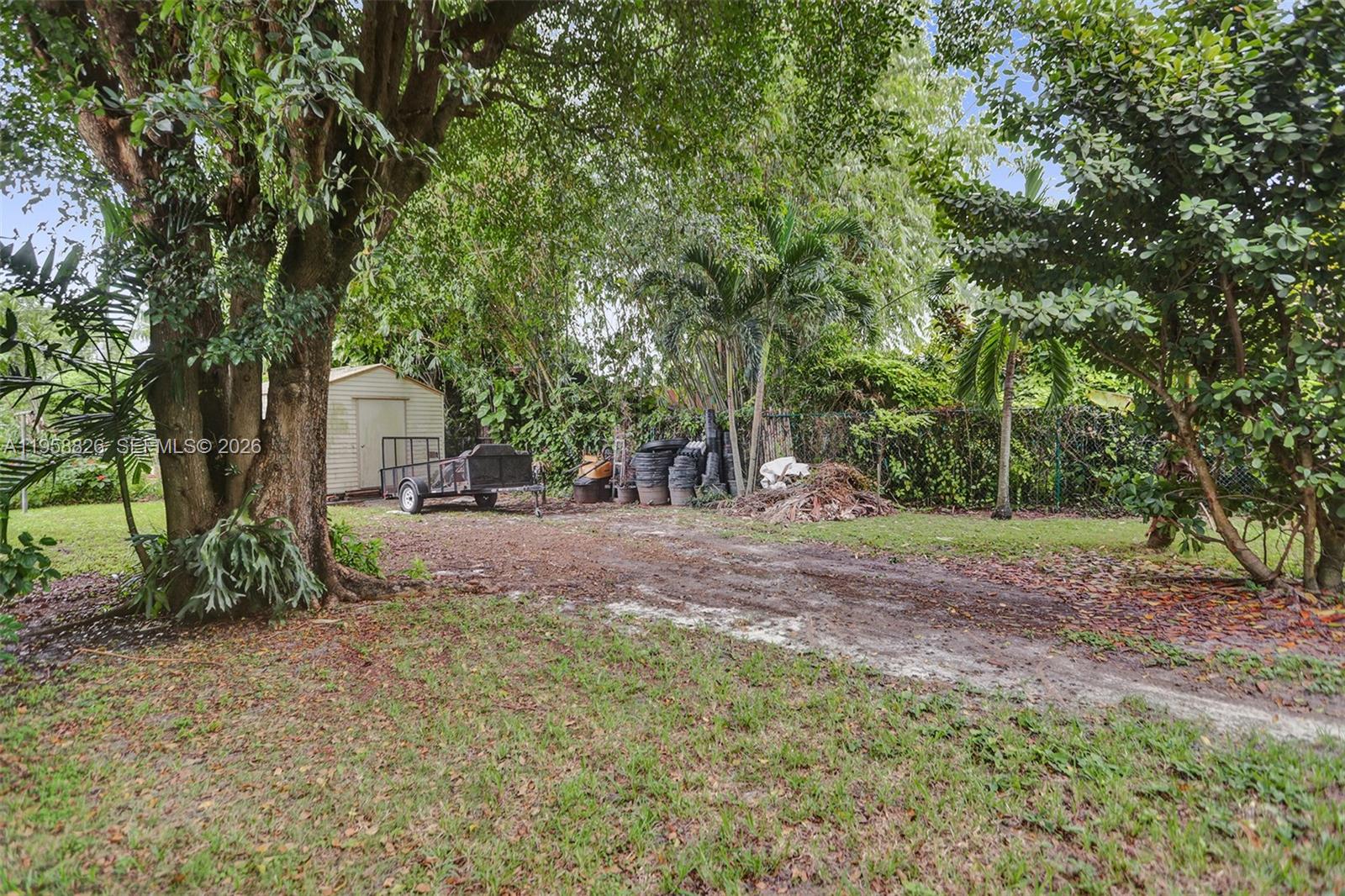 3255 Southwest 60th Avenue Miami, FL 33155 - Photo 11 of 42 a view of a tree in the middle of a yard