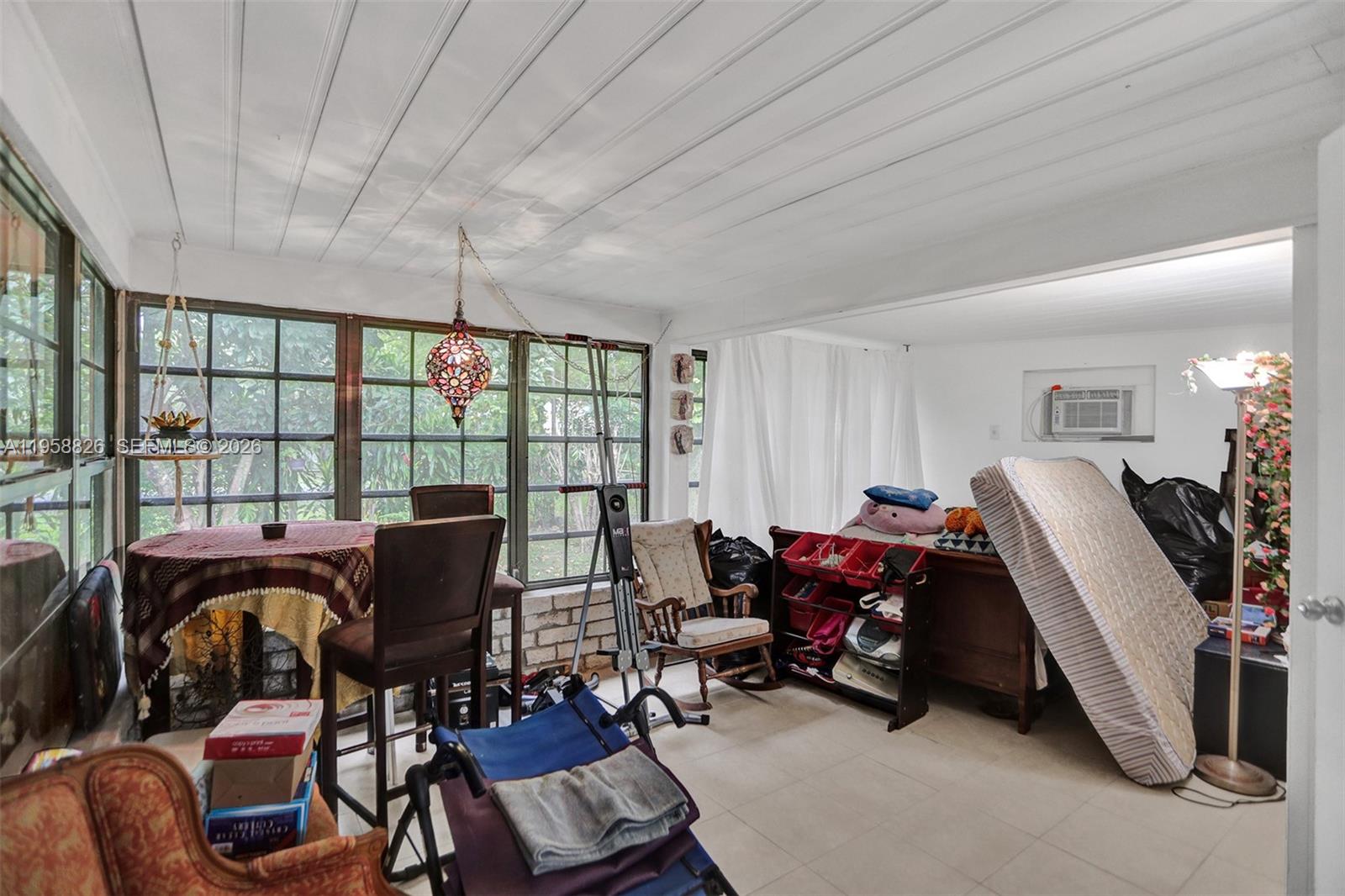 3255 Southwest 60th Avenue Miami, FL 33155 - Photo 14 of 42 a view of a workspace with furniture and a window