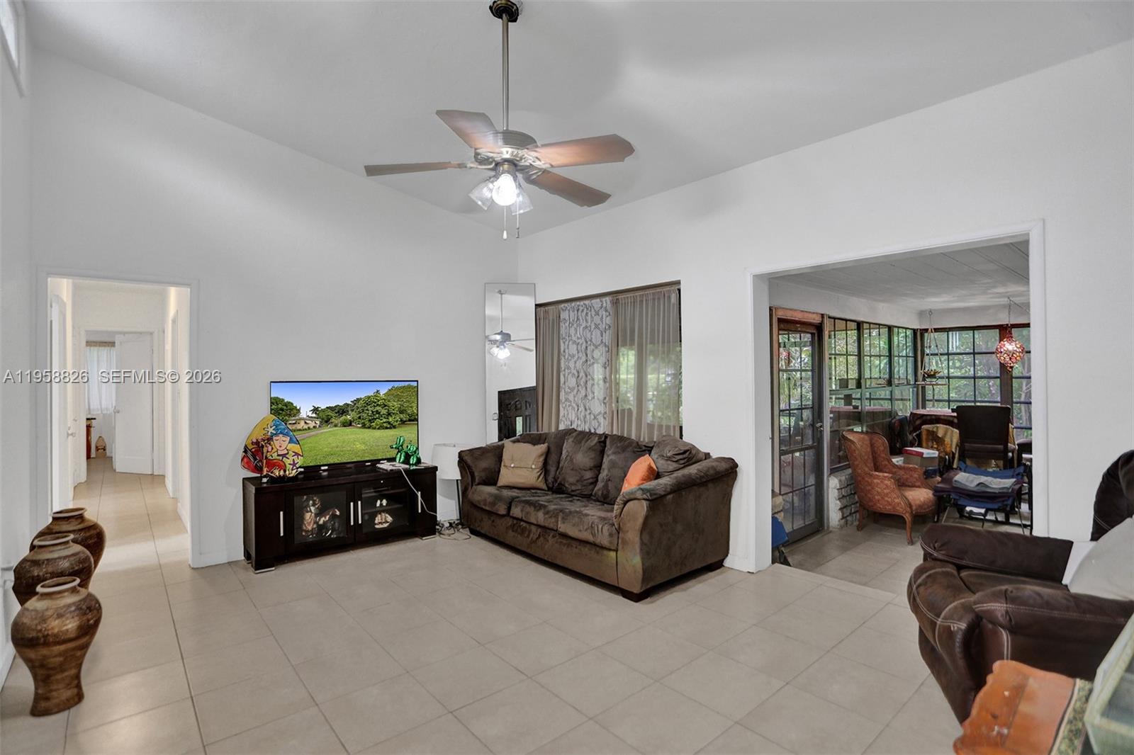 3255 Southwest 60th Avenue Miami, FL 33155 - Photo 17 of 42 a living room with furniture and a flat screen tv