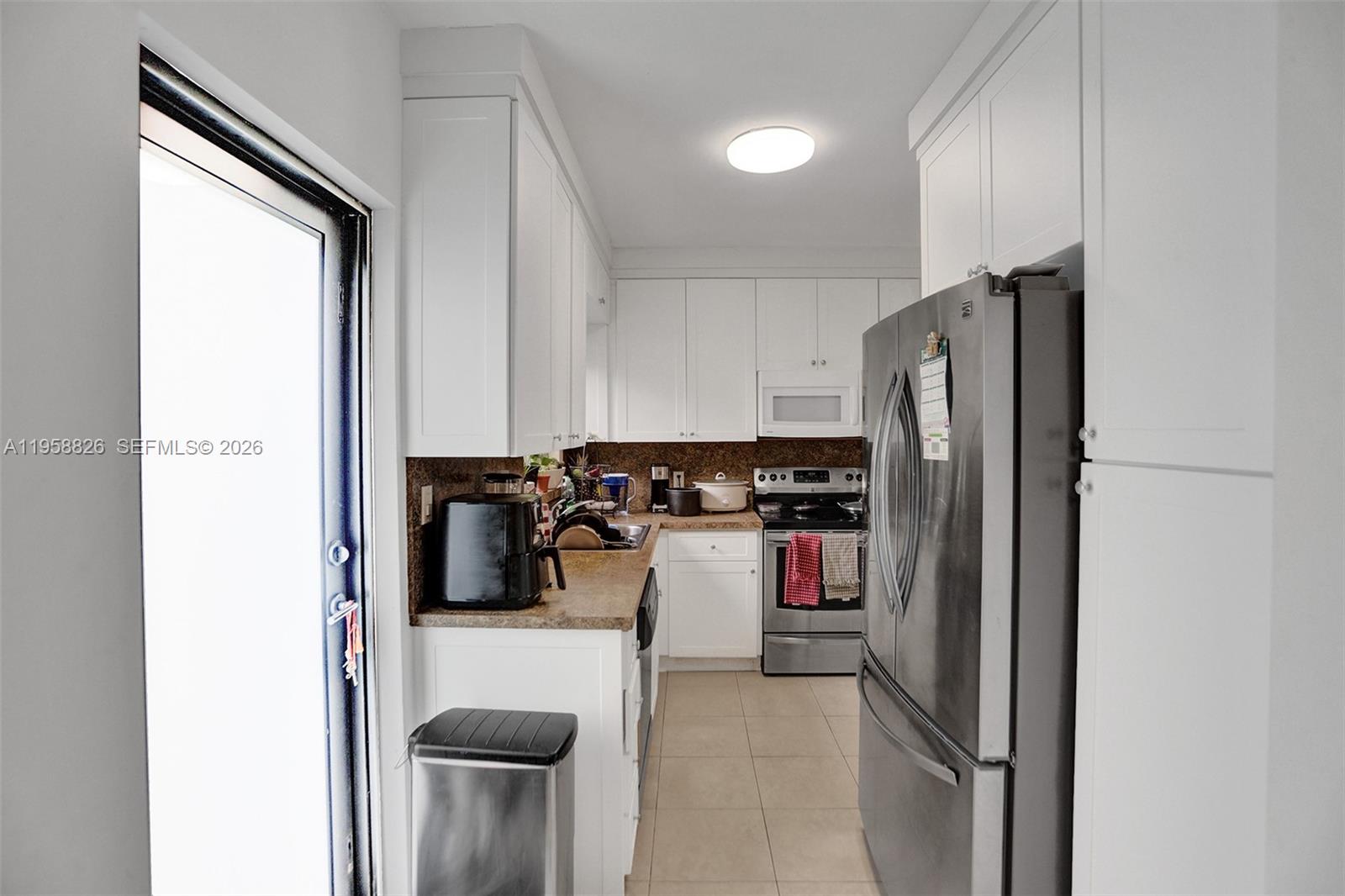 3255 Southwest 60th Avenue Miami, FL 33155 - Photo 21 of 42 a kitchen with a refrigerator and a sink