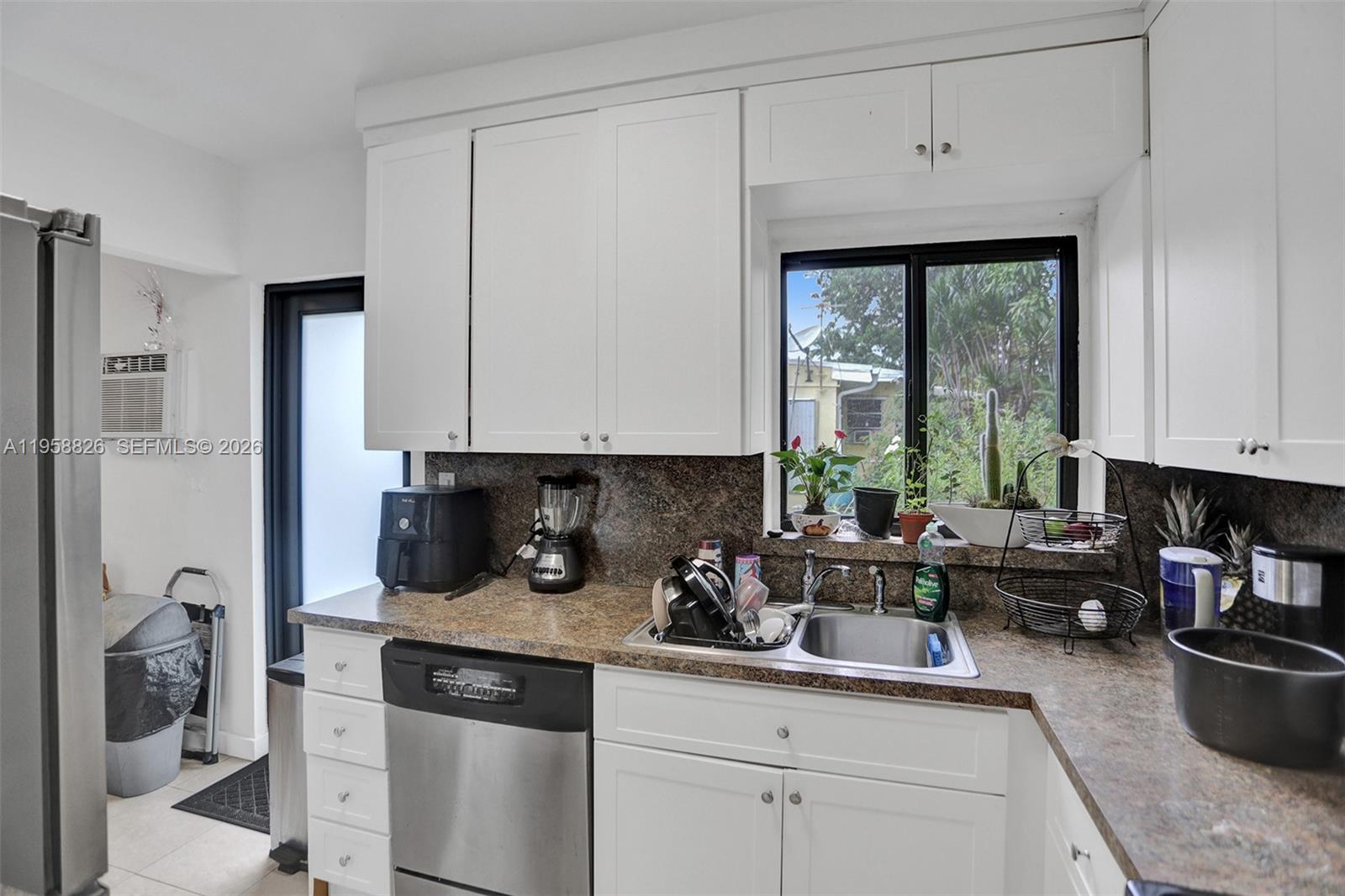 3255 Southwest 60th Avenue Miami, FL 33155 - Photo 24 of 42 a kitchen with stainless steel appliances granite countertop a sink stove and cabinets