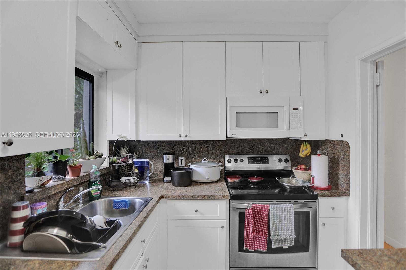 3255 Southwest 60th Avenue Miami, FL 33155 - Photo 26 of 42 a kitchen with a sink and cabinets
